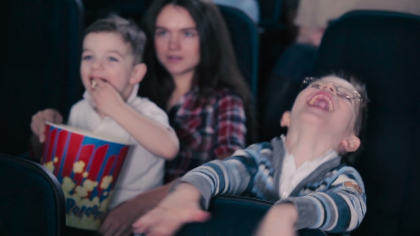 The Boy in Glasses Are Watching the Movie in the Cinema