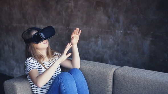 Young Woman Using VR-helmet at Home. Handheld Shot