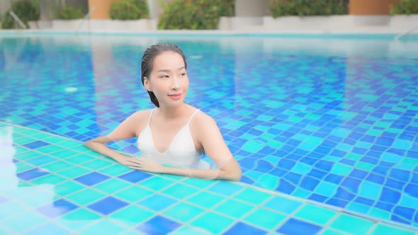 Sexy Exotic Woman Enjoying in Water of Blue Swimming Pool on Luxury Vacation, Full Frame Slow Motion