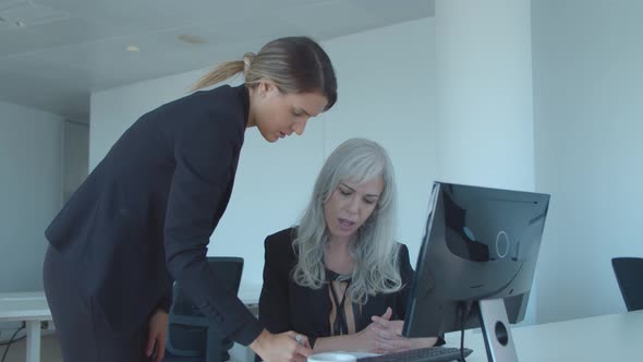 Serious Female Leader Asking Manager To Check Report