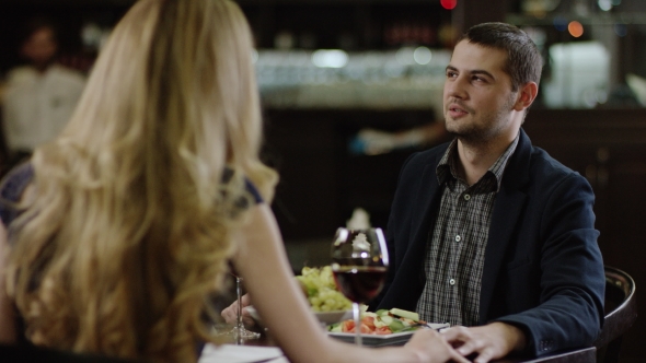 Back View of a Blondie Talking To Boyfriend in Restaurant