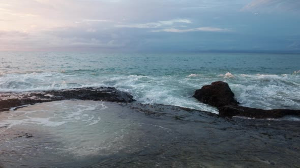 View of the Rocky Beach, Clouds and Sunset at Sea