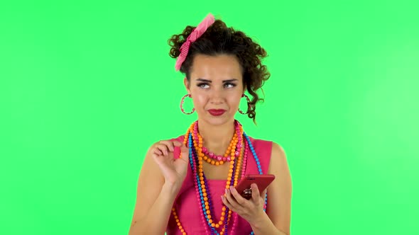 Young Smiling Woman Texting on Her Phone on Green Screen