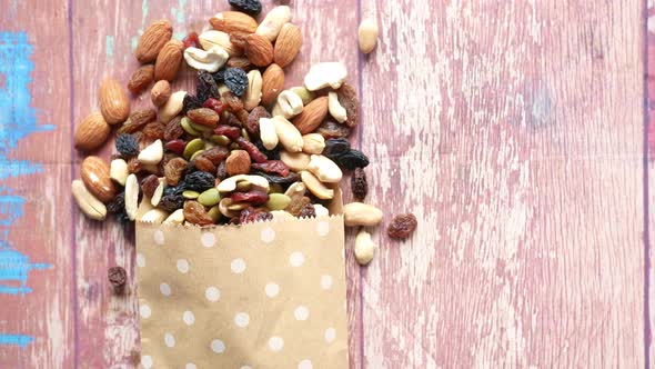 Close Up of Many Mixed Nuts Spilling From a Paper Bag