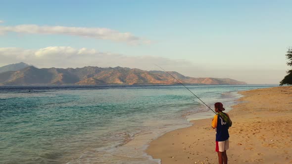 Catching fish for Happy traveller on a trip enjoys life at beach on summer white sand and blue 4K ba