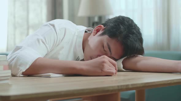 Close Up Of Asian Man Student Sleeping While Studying At Home