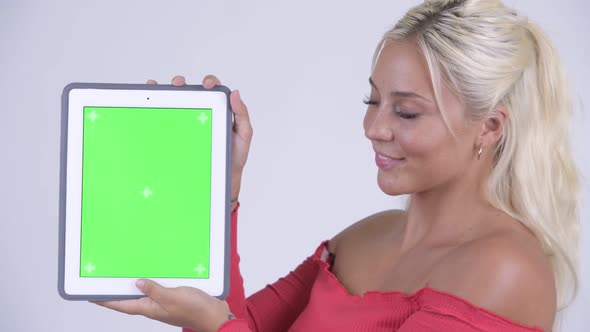 Happy Young Beautiful Blonde Woman Showing Digital Tablet