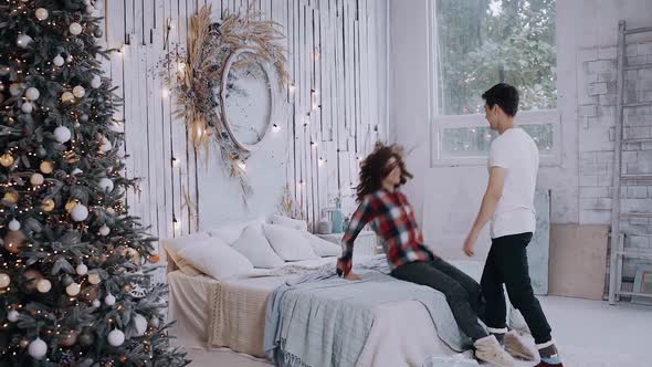 Young Couple Spending Time at Home in the Christmas Bedroom