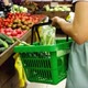 Woman with shopping basket walking along rows in grocery and taking vegetables - VideoHive Item for Sale