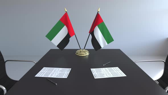 Flags of the United Arab Emiratesand Papers on the Table alt