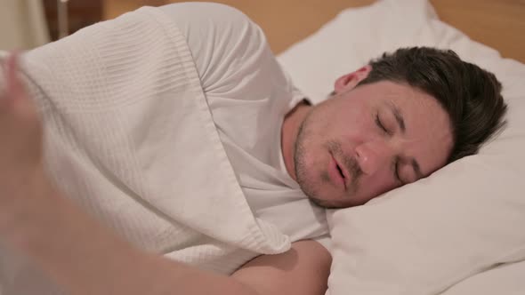 Middle Aged Man Waking up from Nightmare in Bed