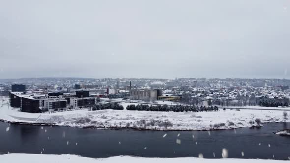 New modern apartment buildings on Neris river coast in Kaunas city, Vilijampole during snowfall. Aer