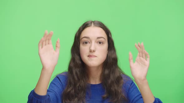 Portrait of an Excited Young Girl Banging Her Fists on Glass Waving Calling Someone and Gesturing I