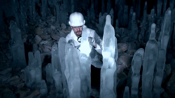 A Scientist Studying Ice Stalagmites in the Cave