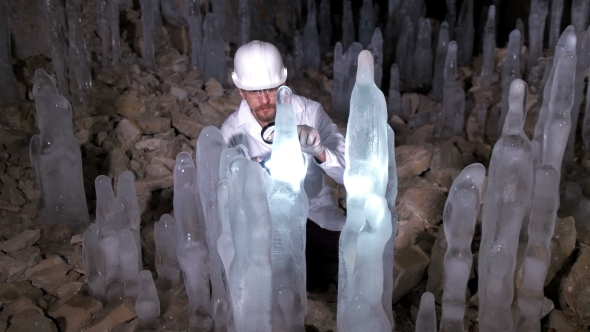 A Scientist Studying Ice Stalagmites in the Cave alt