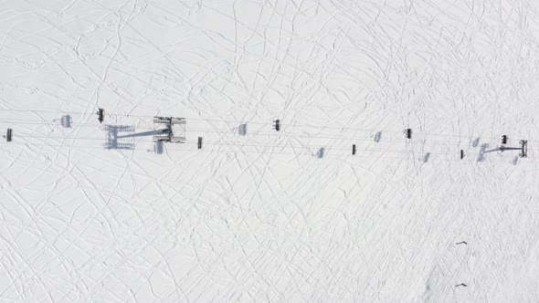 Top Aerial View From Above Ski Lift Moving on Cableway on Ski Resort at Winter