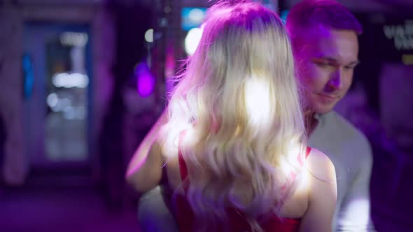 Romantic Loving Young Couple Dancing in Night Club Lights Indoors