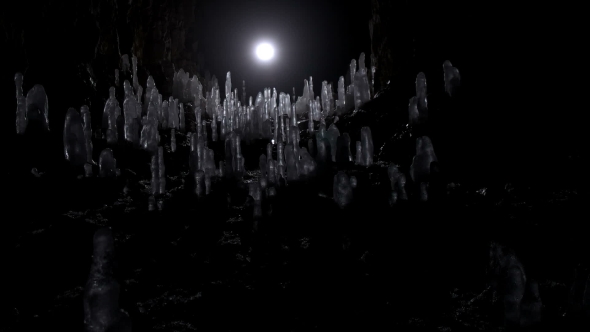 A Scientist Studying Ice Stalagmites in the Cave alt