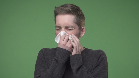 Young Man Has Caught Cold and Using Handkerchief for Runny Nose