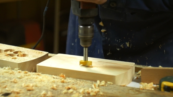 Drilling a Hole Into Wood. alt