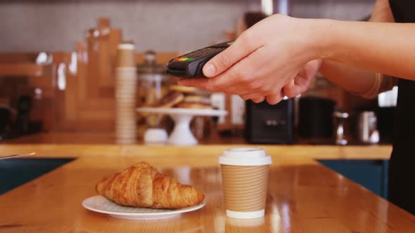 Man paying bill through payment terminal