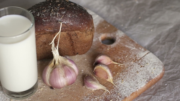 Garlic, Bread and Milk on the Table .