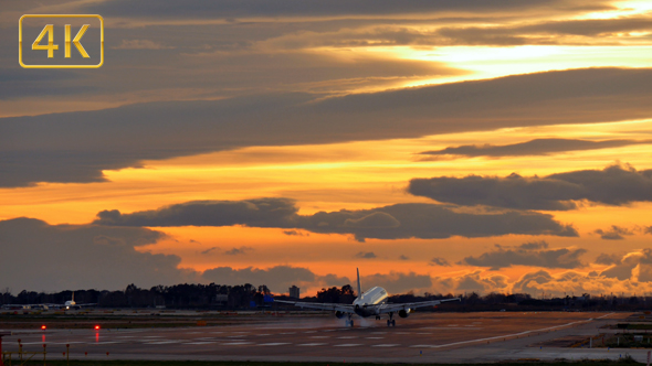 Commercial Aircraft Landing at Barcelona Airport at Sunset