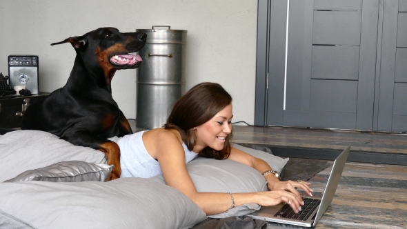 Young Pretty Woman with Black Doberman Dog