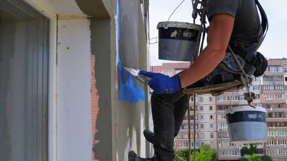 Industrial Climber Using Trowel Putty Glue on Fiberglass Mesh To Insulate Facade