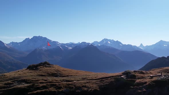 Beautiful aerial in mountain panorama with matterhorn, swiss flag and one hiker