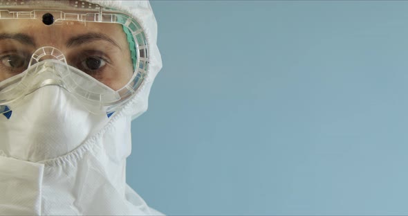 Doctor in Protective Suit with Face Mask, Eyeglasses and Gloves Portrait. Nurse in Protective Suit
