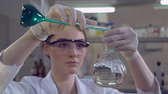 Attractive Professional Scientist Carrying Out Experiments. alt