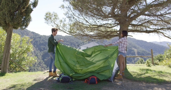 Two Travellers Putting Up Tent