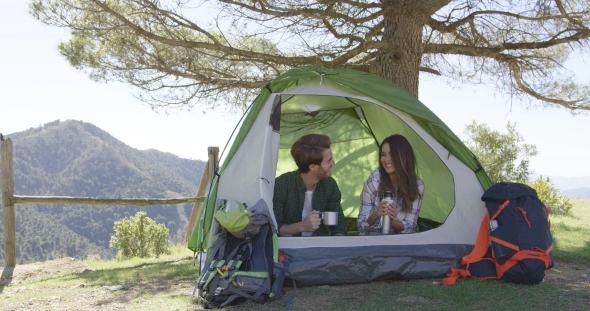 Smiling People Having Rest in Tent