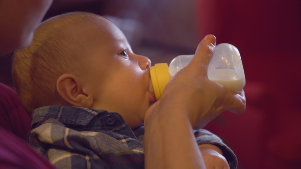 Cute Baby Enjoy Milk in Bottle