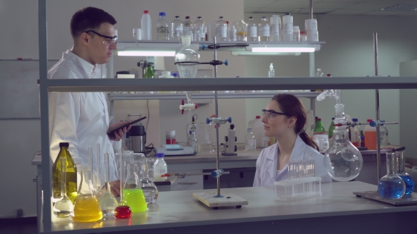 Adult Scientists at Work Talking and Smiling.