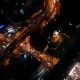Aerial Night Vertical View of Skyscraper Rooftops and Illuminated Streets in a Modern City - VideoHive Item for Sale