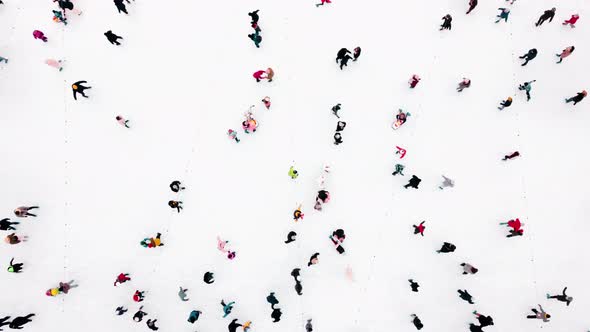 Aerial Drone View Over Many People Skating on an Openair Ice Rink in Winter