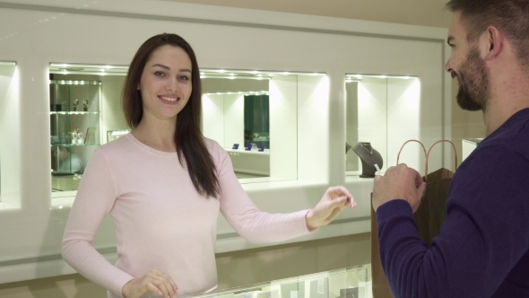 Female Seller Gives Customer His Purchase at the Jewelry Shop