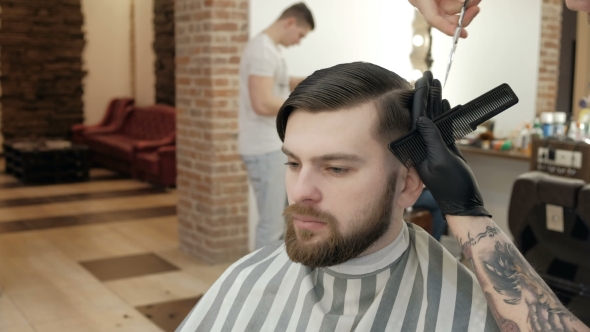 Master Makes Beards Correction in Background Salon Barbershop