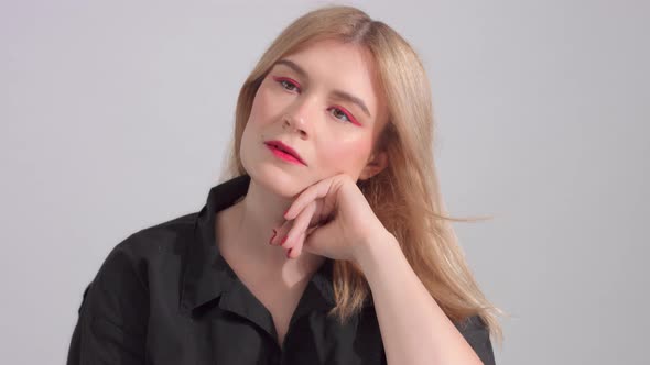 Blonde Woman with Bright Red Makeup in Studio