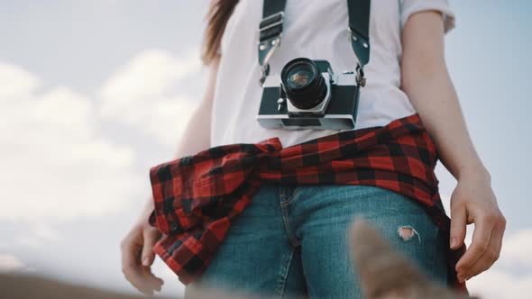 Female Tourist with Wintage Camera. Lov Angle No Face Shot