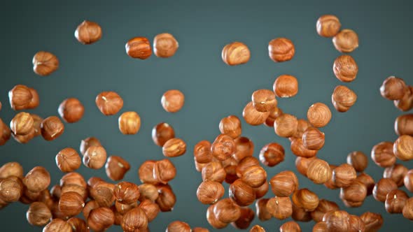 Super Slow Motion Shot of Flying Hazelnuts After Being Exploded on Grey Background at 1000 Fps