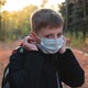 Child Boy Takes Off His Medical Mask Outdoors - VideoHive Item for Sale