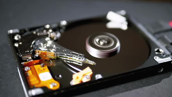 Opened Hard Disk Drive with Spinning Platter. Move of Magnetic Head. Slow Motion