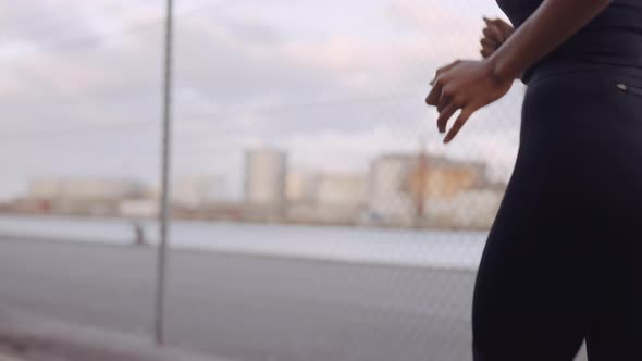 Young Woman In Black Sportswear Jogging Along Harbour