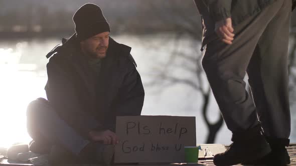 Male Begging for Money with Cardboard Sign
