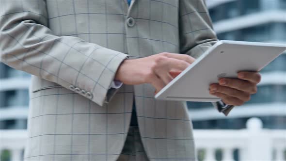 Hands Of Businessman Working On Digital Tablet Computer Outdoor.