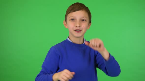 A Young Cute Boy Dances and Smiles at the Camera - Green Screen Studio