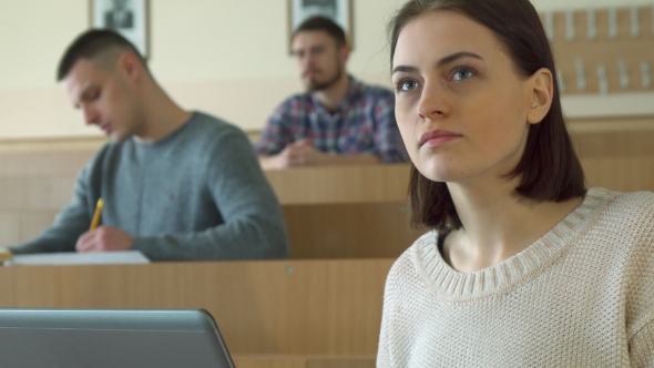 Female Student Notes on Laptop